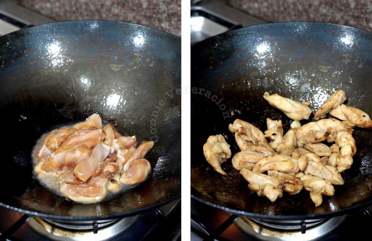 Stir frying seasoned chicken in carbon steel wok