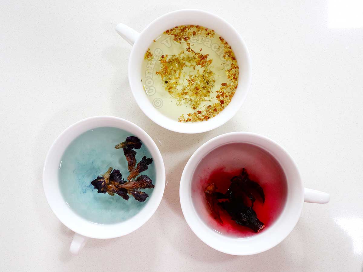 Osmanthus, butterfly pea flowers and roselle steeping in hot water