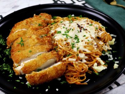 Pasta in tomato cream sauce with chicken katsu sprinkled with parsley