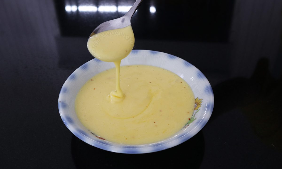 Hollandaise sauce, in ribbon stage, falling from a spoon
