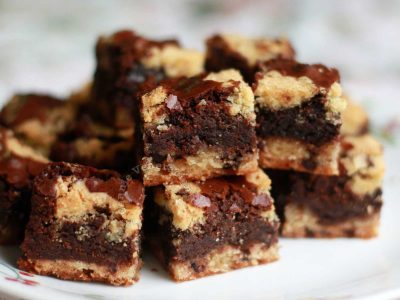Chocolate Chip Cookie Dough Brownies Stacked on White Plate