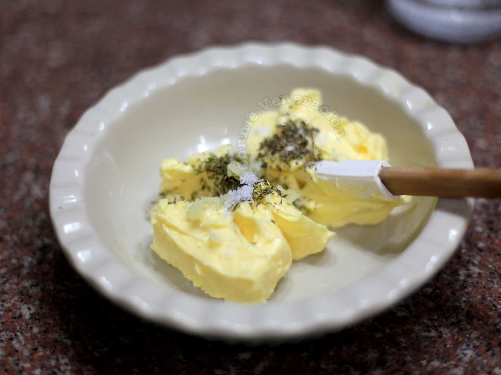 Stirring dried herbs and spices into softened butter