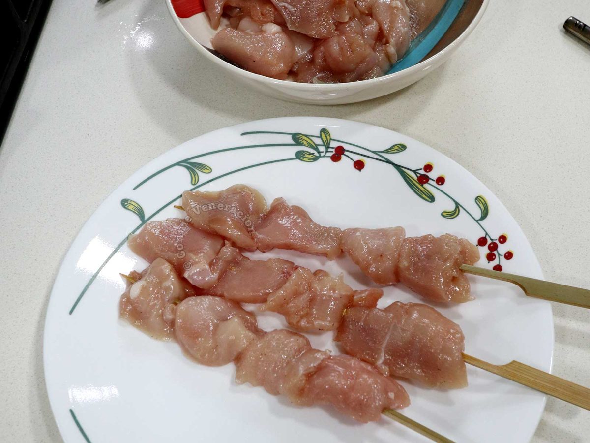 Pieces of chicken breast fillet threaded with bamboo skewers