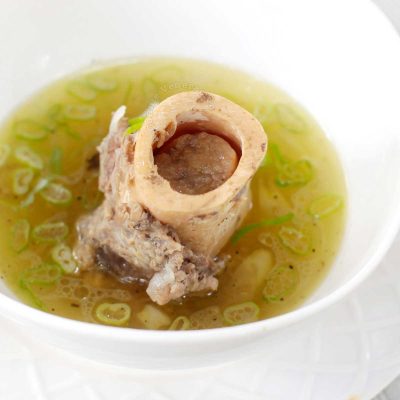 Bone marrow soup garnished with scallions