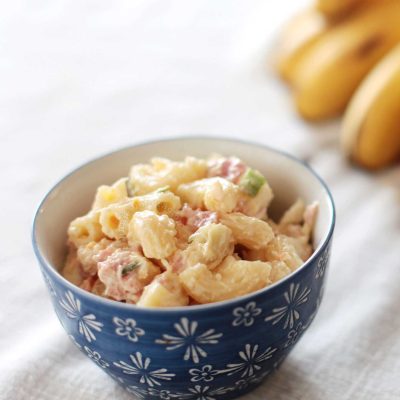 Bacon macaroni salad with bananas in background