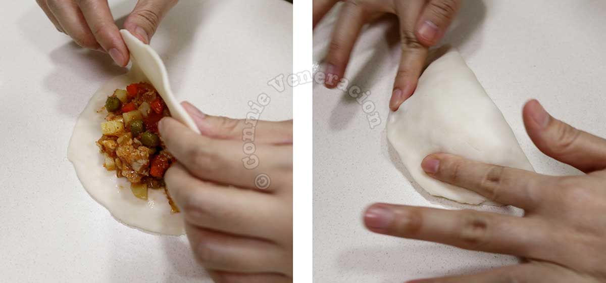 Folding empanada dough to enclose the filling, and pressing the seams to seal