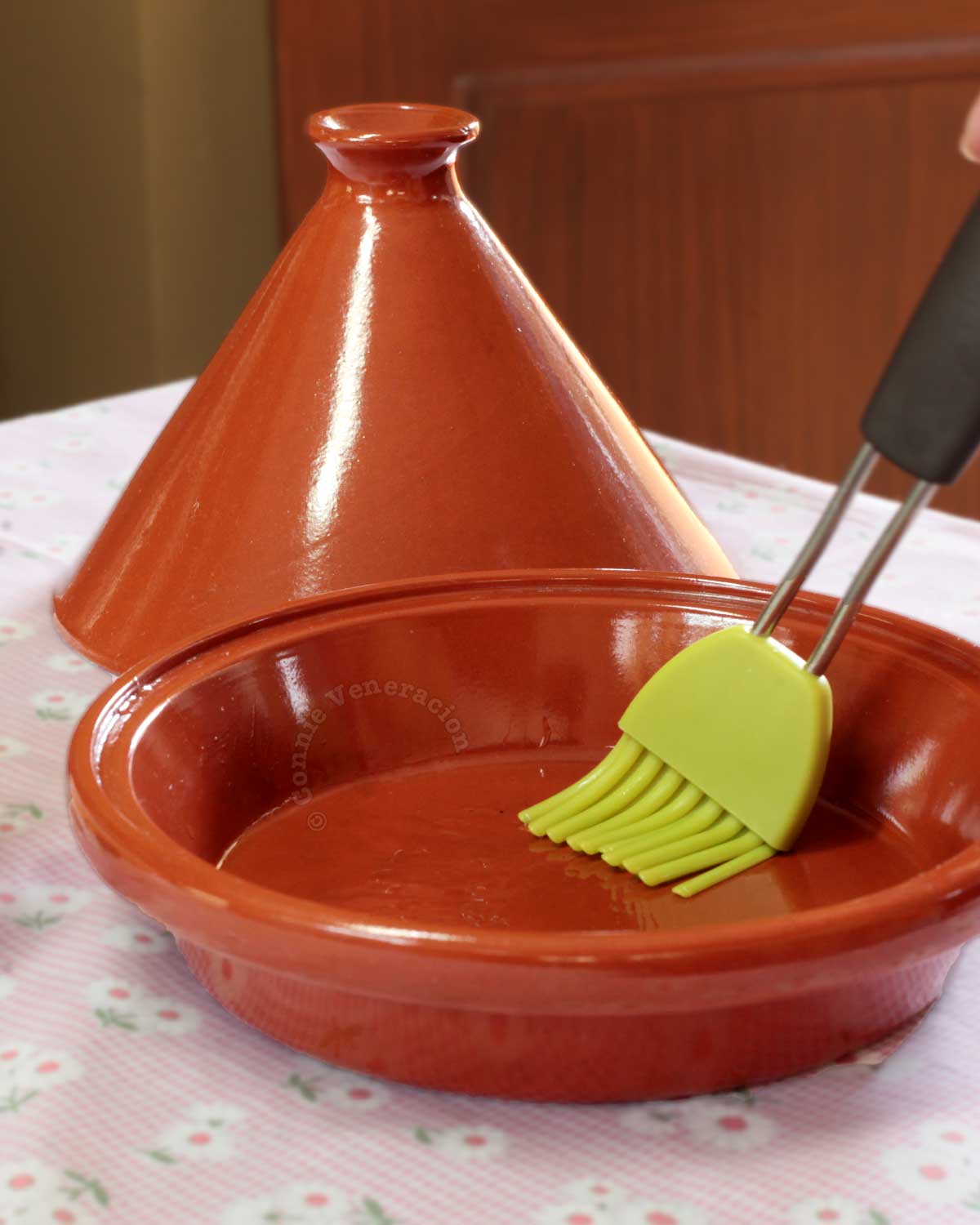 Brushing a tajine pot with oil