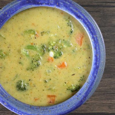 Broccoli and carrot chowder in blue stoneware bowl