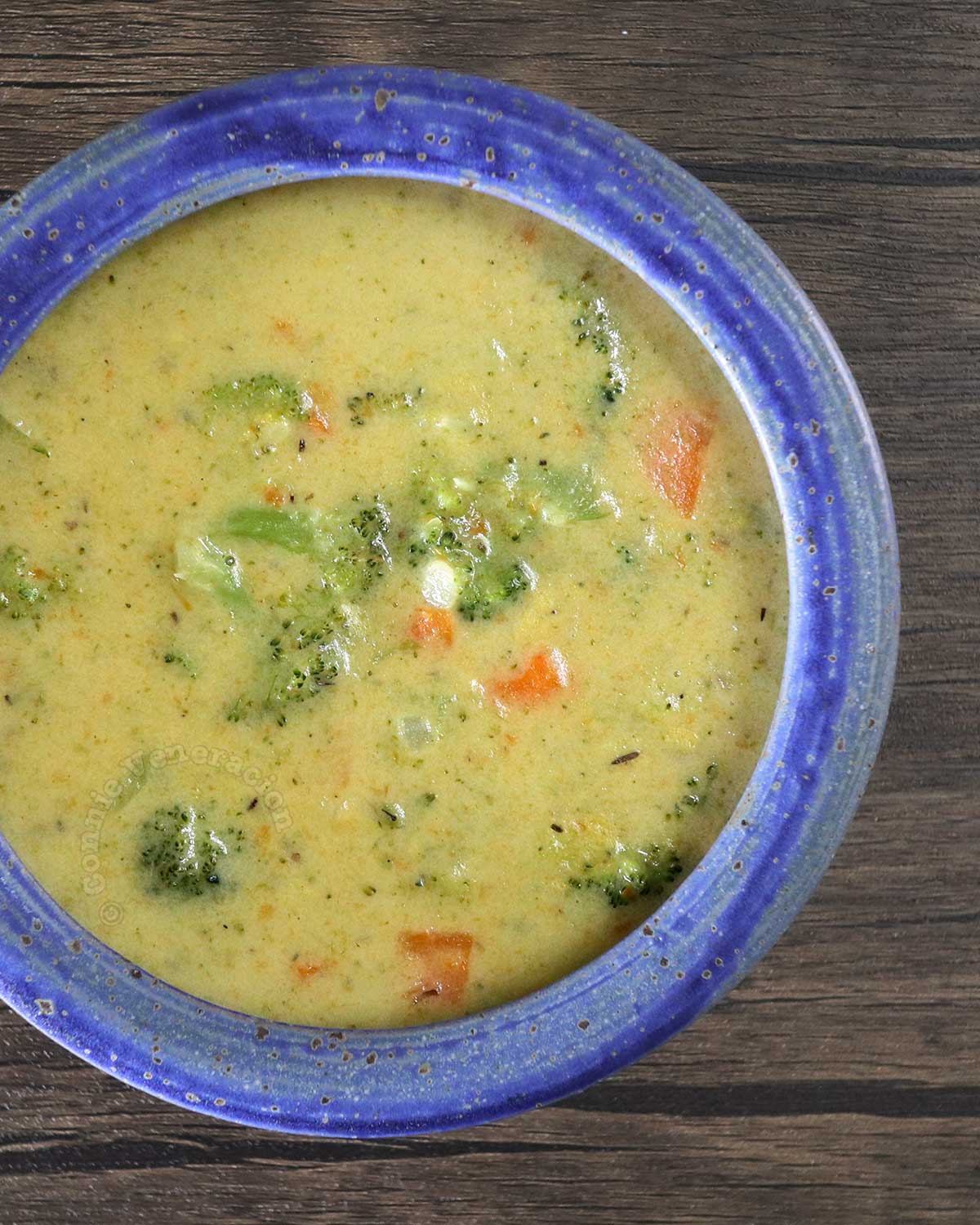 Broccoli and carrot chowder in blue stoneware bowl