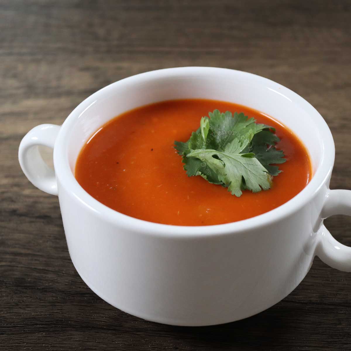 Tomato soup garnished with cilantro