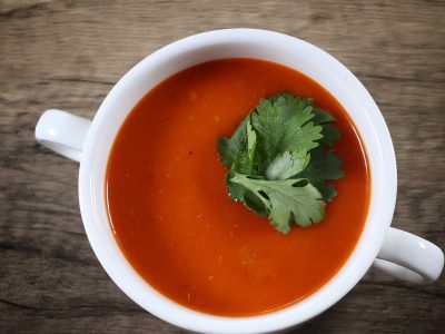 Smooth tomato soup in white bowl