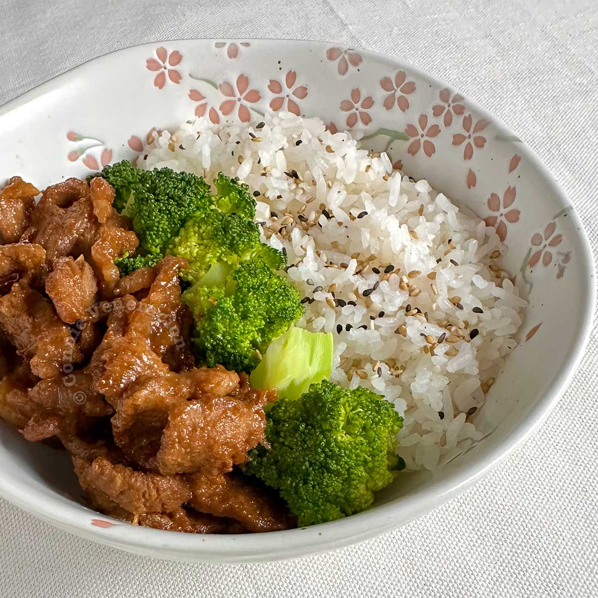 Pork bulgogi in bowl with rice and broccoli florets