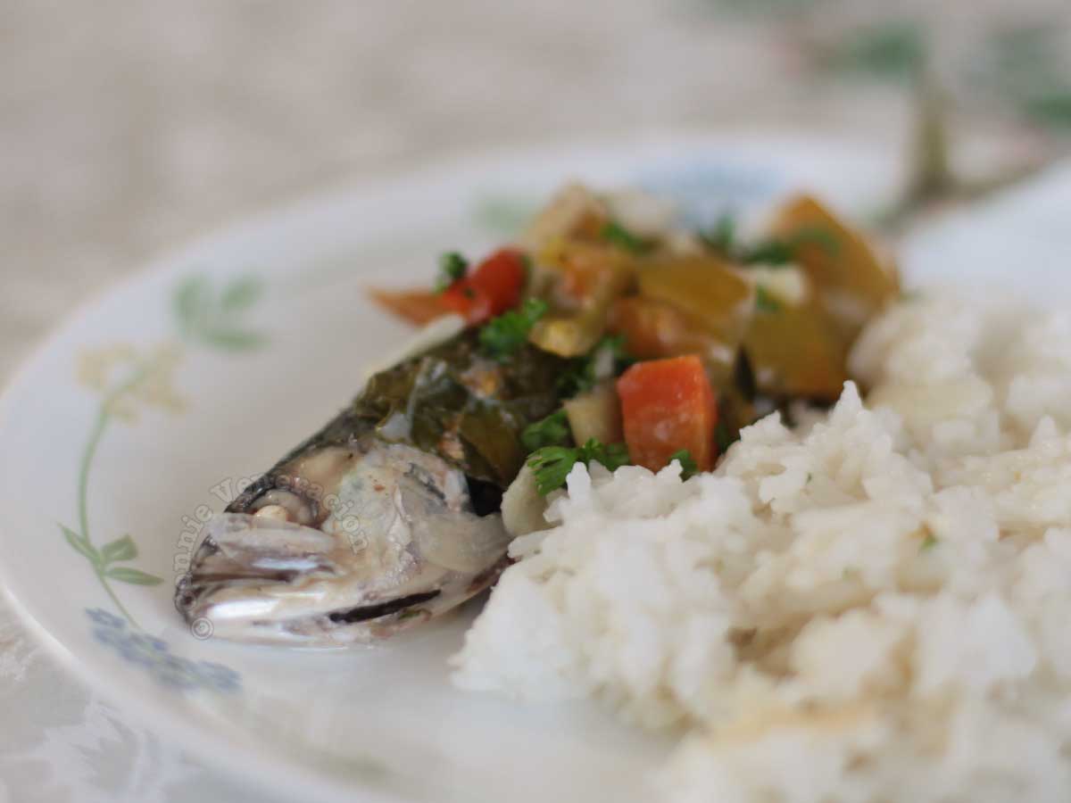Chinese broccoli-wrapped mackerel in coconut milk with rice on plate