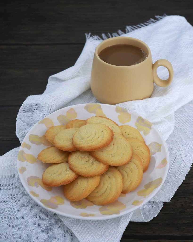Cookies on a plate and coffee in yellow mug