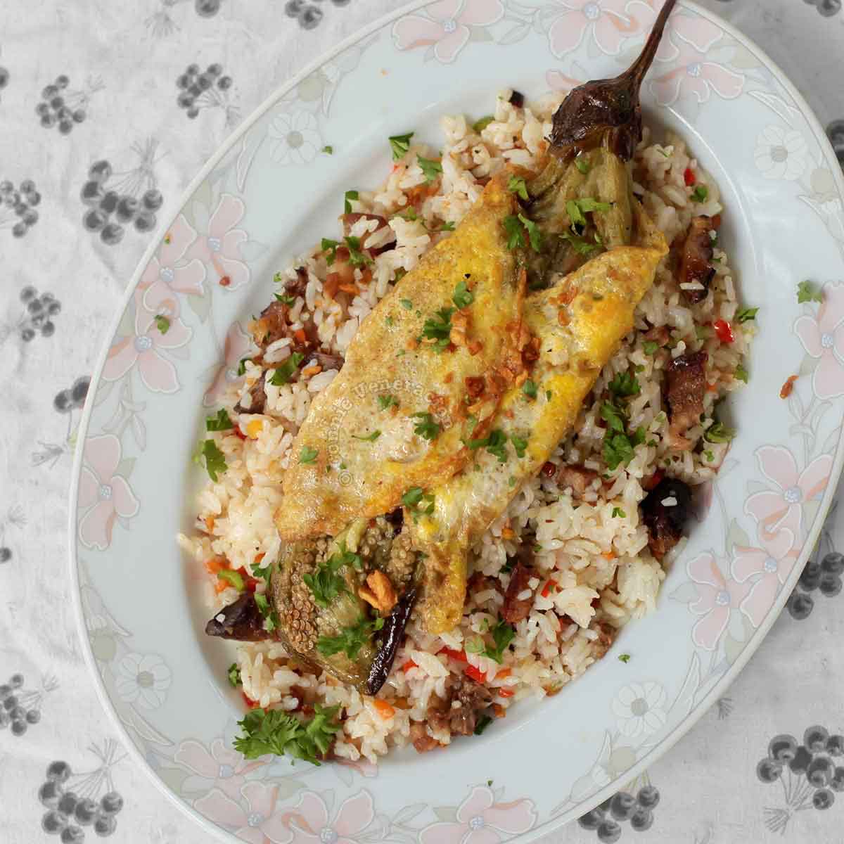 Eggplant omelette (tortang talong) on top of fried rice
