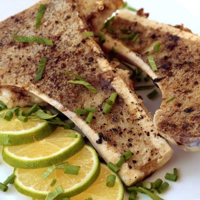 Grilled bone marrow sprinkled with mint and served with lemon slices