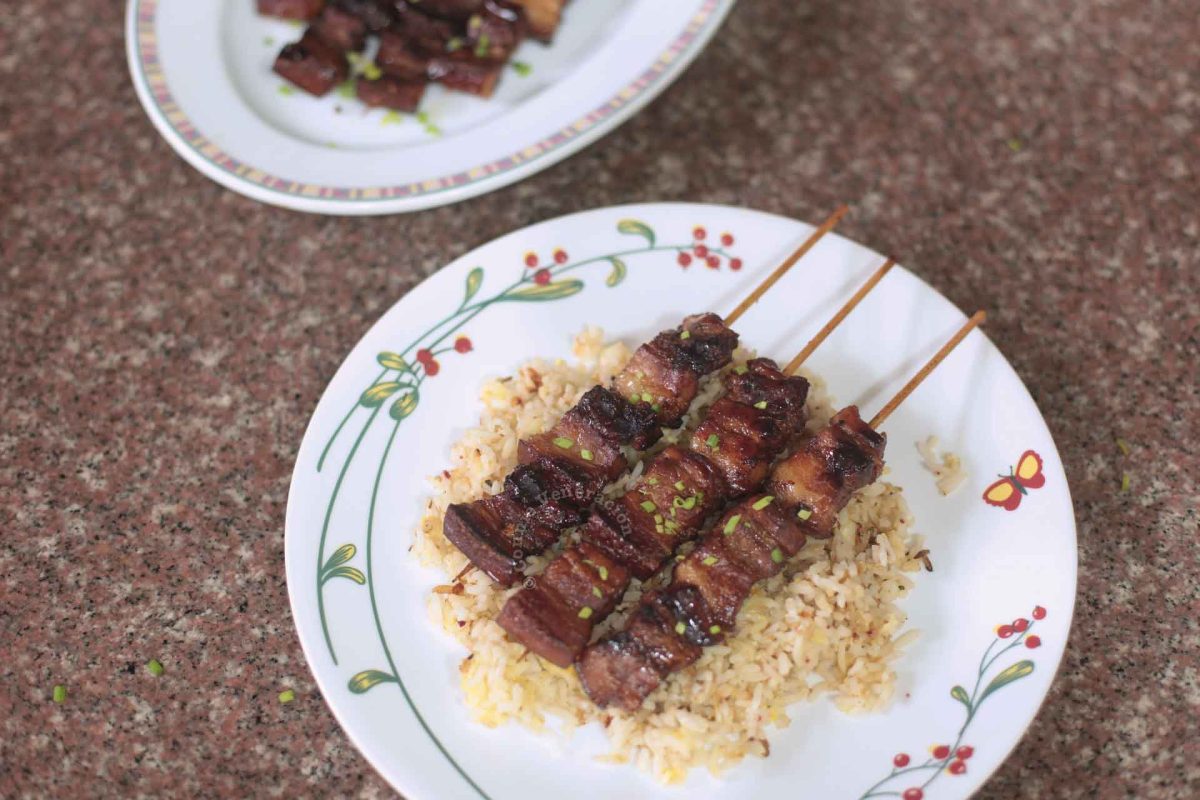 Skewered and grilled Filipino pork adobo served with rice