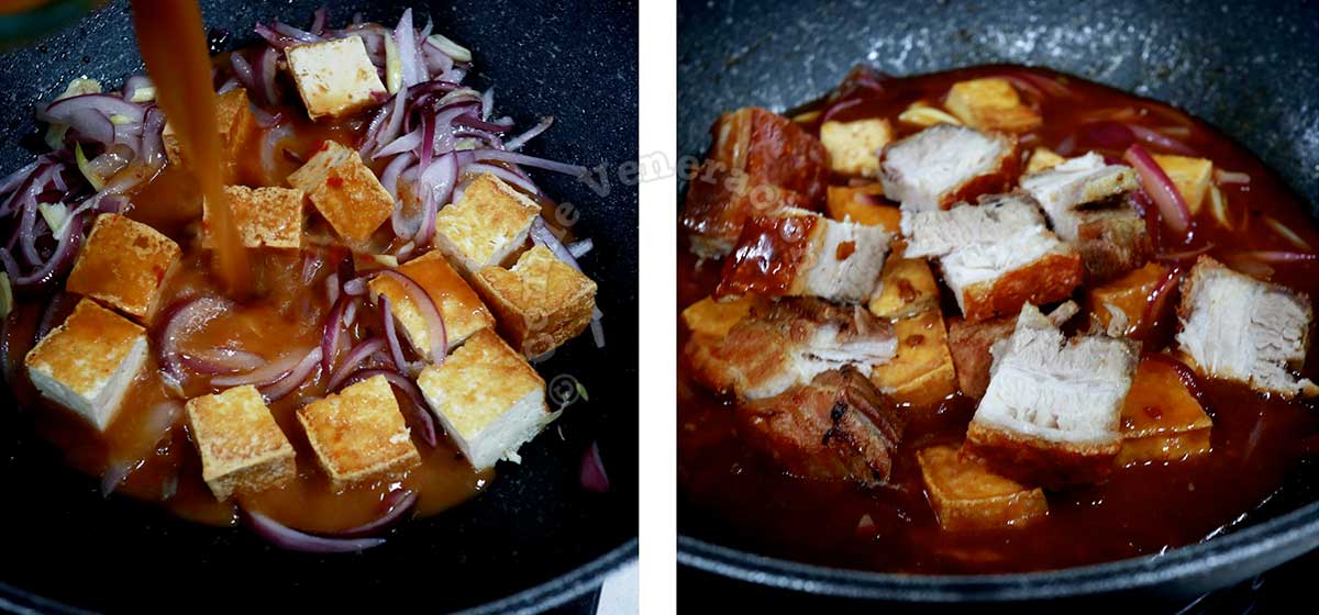 Pouring chili bean sauce over tofu in pan before adding cubed crispy pork belly