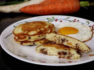 Pancakes stuffed with sausage meat served with egg