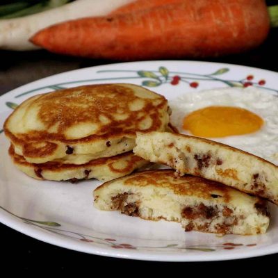 Pancakes stuffed with sausage meat served with egg