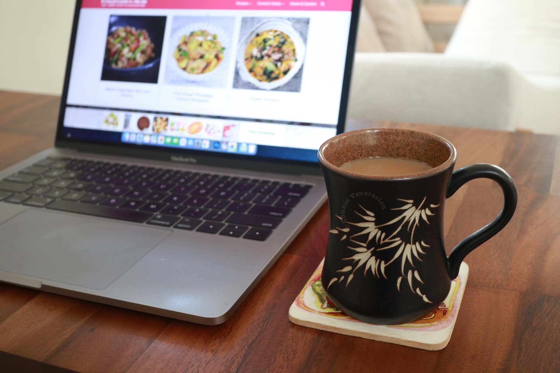 Black coffee mug with bamboo design, and Macbook Pro