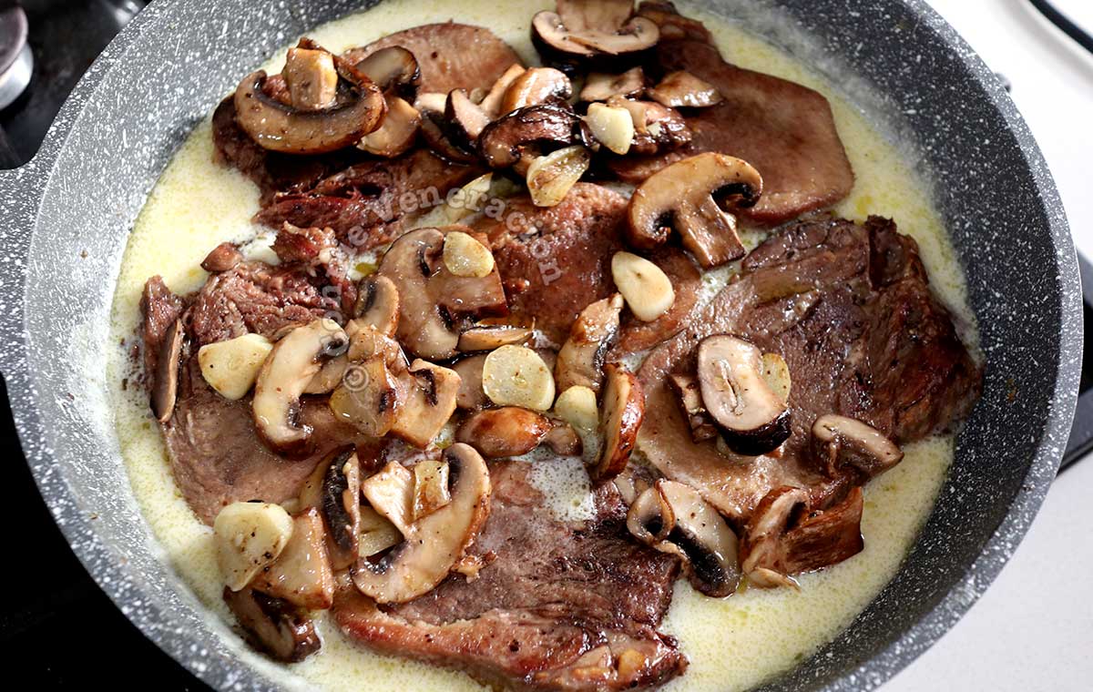 Adding beef tongue and mushrooms to Bechamel sauce in pan