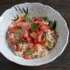 Garlic, tomato and basil fried rice topped with bacon