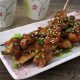 Spicy grilled skewered beef tripe garnished with scallions and sesame seeds