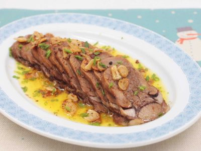 Lengua al Ajillo (Spanish-style Beef Tongue with Garlic) on Serving Plate