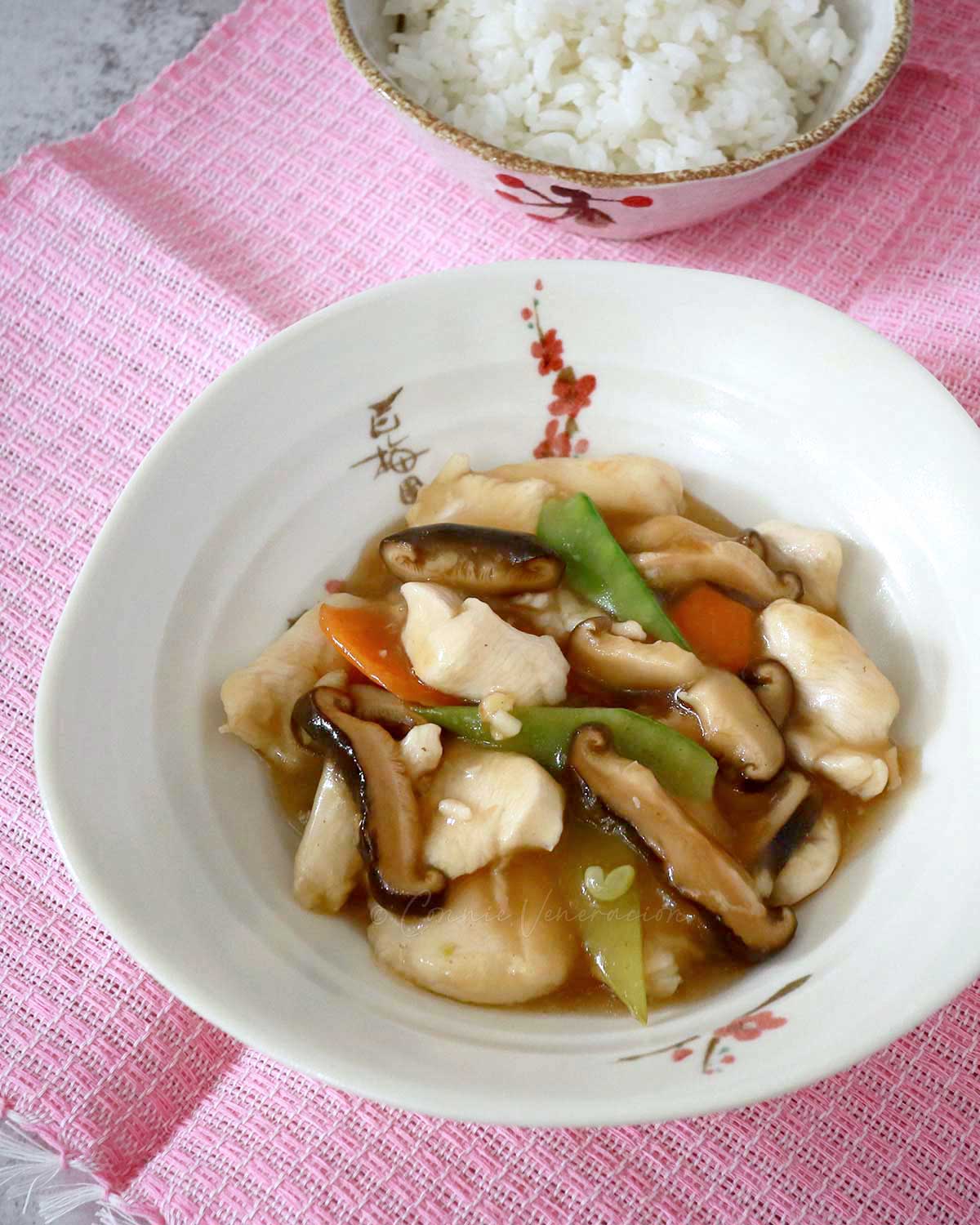 Moo goo gai pan (chicken and mushroom stir fry) in white shallow bowl