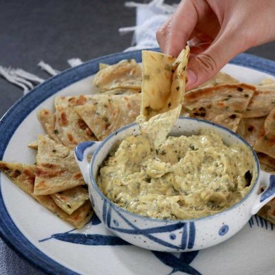 Dipping toasted chives paratha in spring onion cheese dip
