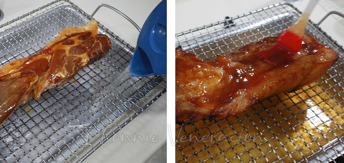 Arranging marinated pork shoulder on rack set over a tray of water