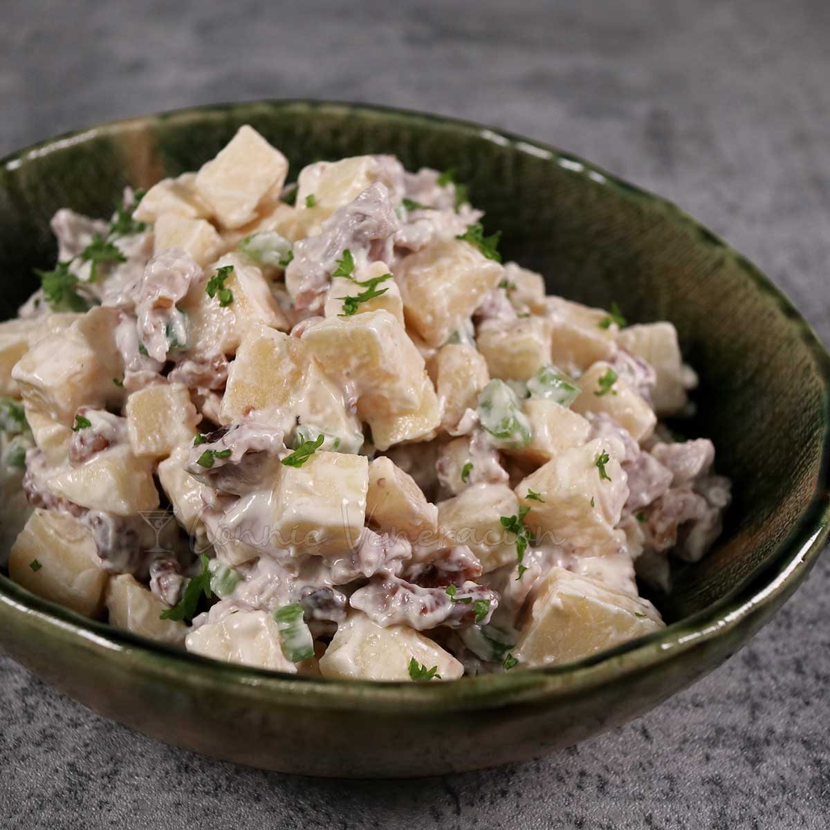 Waldorf-inspired apple and chicken salad in green stoneware bowl