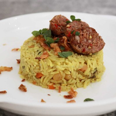 Coconut cream curry rice with sausages on top