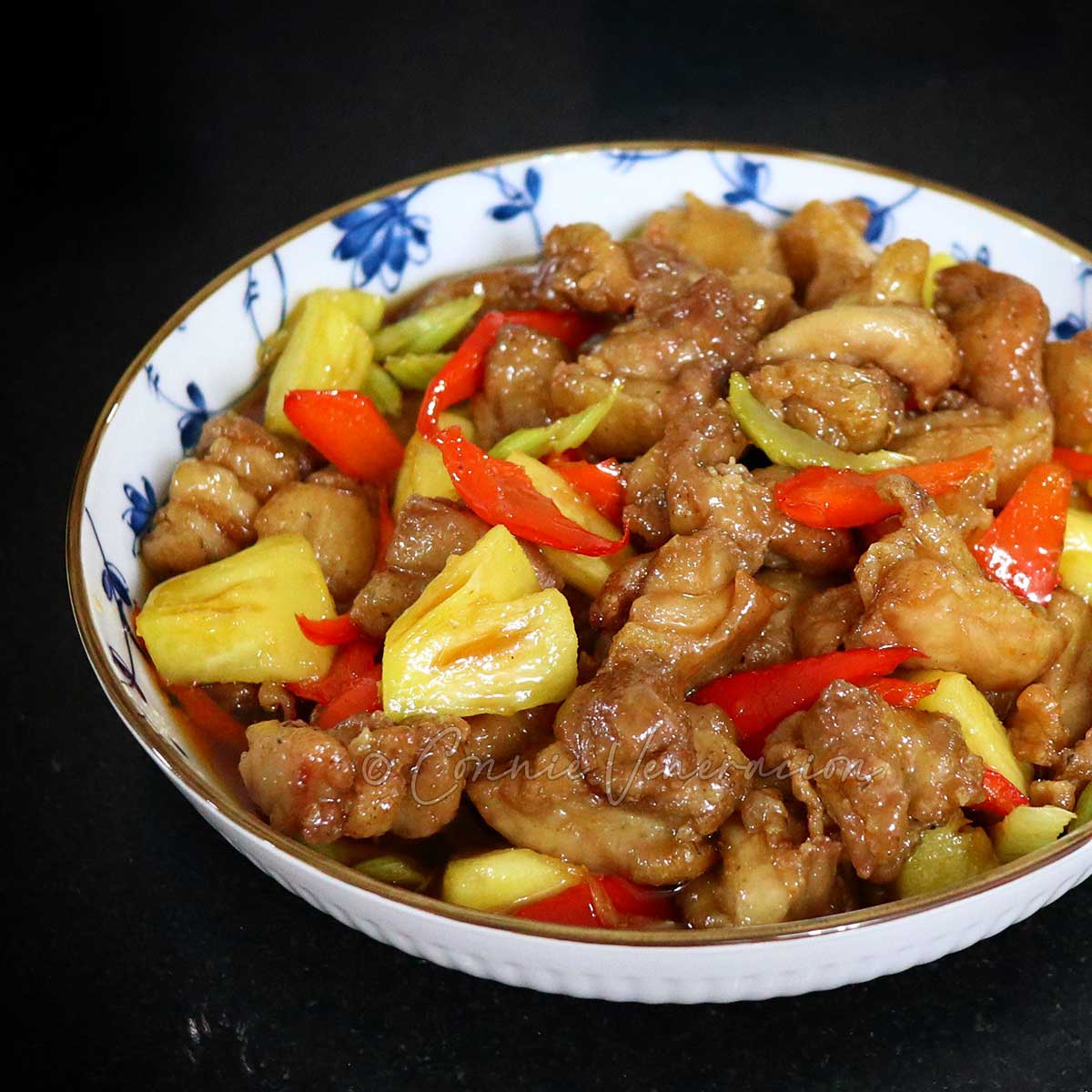 Sweet sour chicken with pineapple and bell pepper in serving bowl