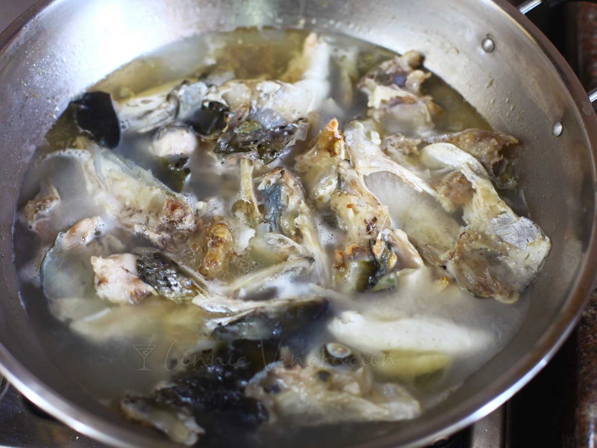 Simmering fish with the heads in a pan