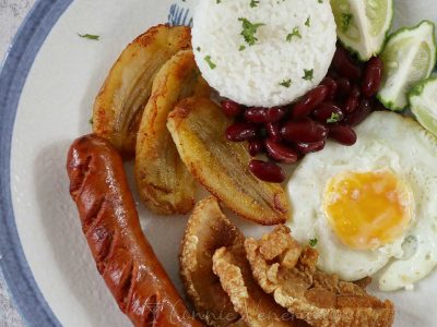 Bandeja paisa: chorizo, chicharron, fried egg and bananas are served with rice and beans