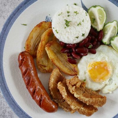 Bandeja paisa: chorizo, chicharron, fried egg and bananas are served with rice and beans