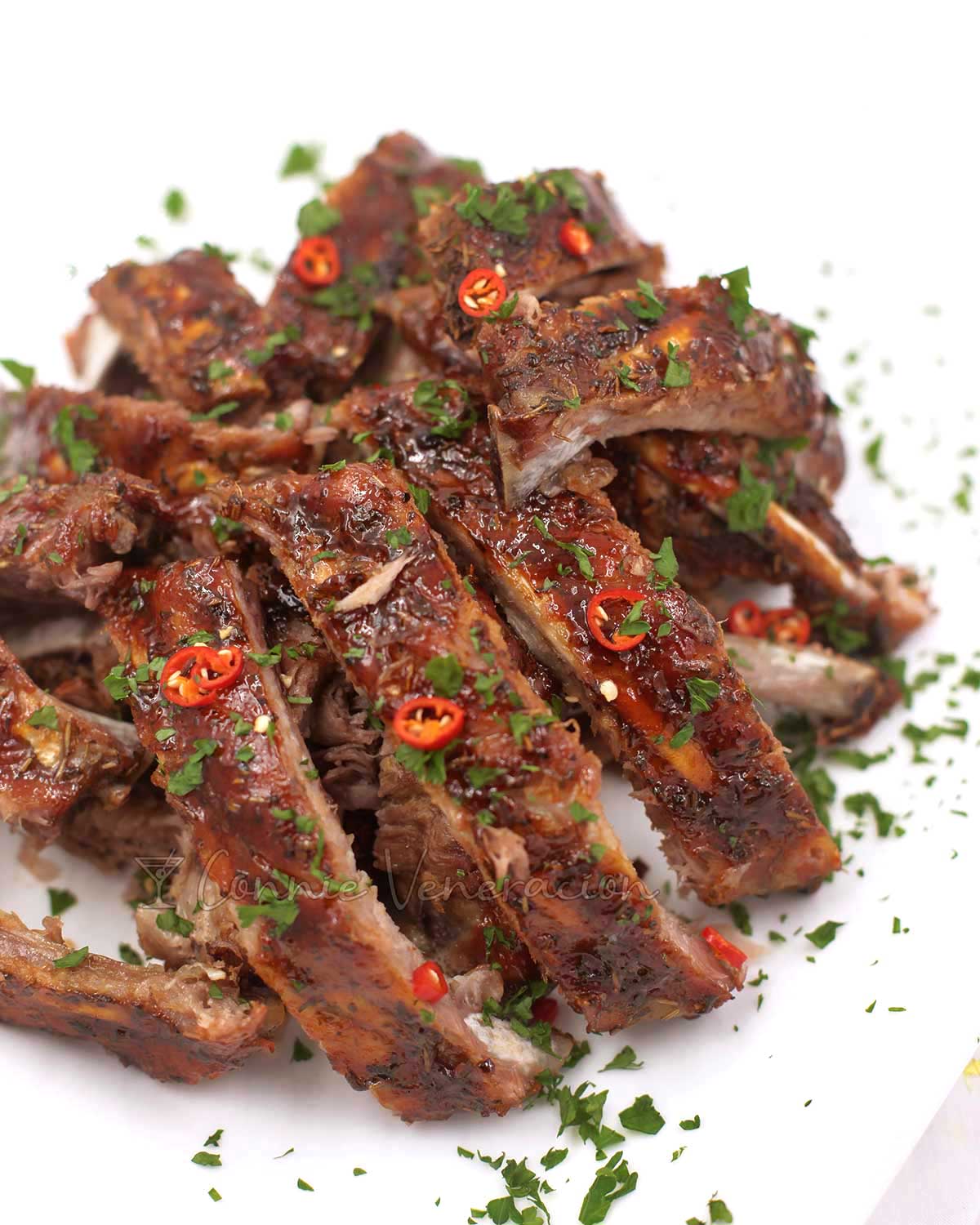 Cajun pork spare ribs garnished with chili slices and parsley