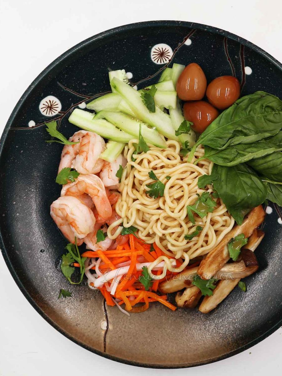 Ramen, cucumber, soy sauce quail eggs, mushrooms, pickled vegetables and shrimps equals Asian cold noodle salad