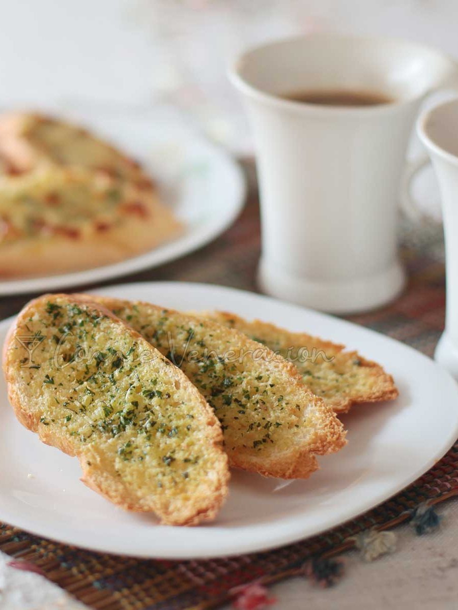 Garlic and herb toast on plate with coffee on the side