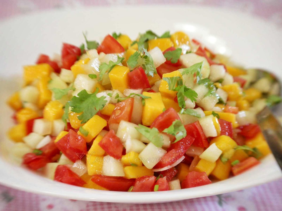 A side salad of ripe mangoes, tomatoes and cucumber
