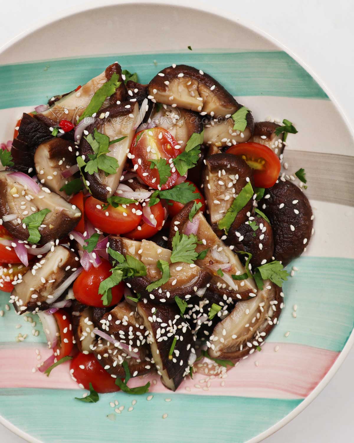 Shiitake and cherry tomato salad in bowl