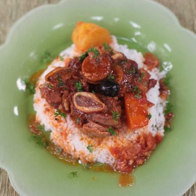 Slow cooker beef stew served over rice