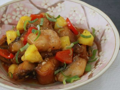 Sweet and sour tilapia fillets with bell pepper, pineapple and scallions