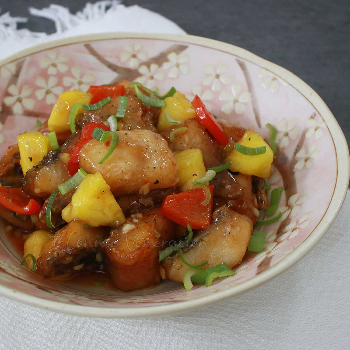Sweet and sour tilapia fillets with bell pepper, pineapple and scallions