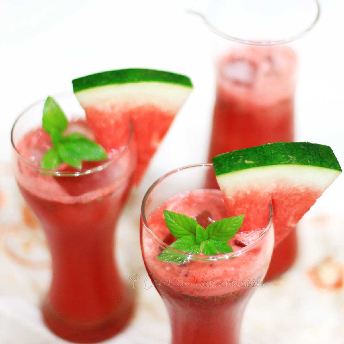 Watermelon and coconut rum cocktail garnished with mint leaves