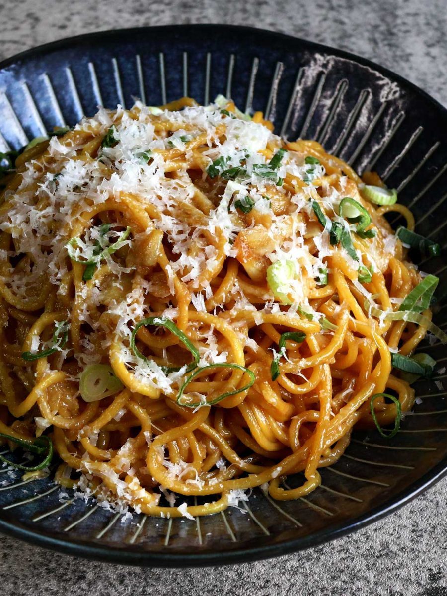 San Franciso-style garlic noodles topped with grated Pecorino and scallions