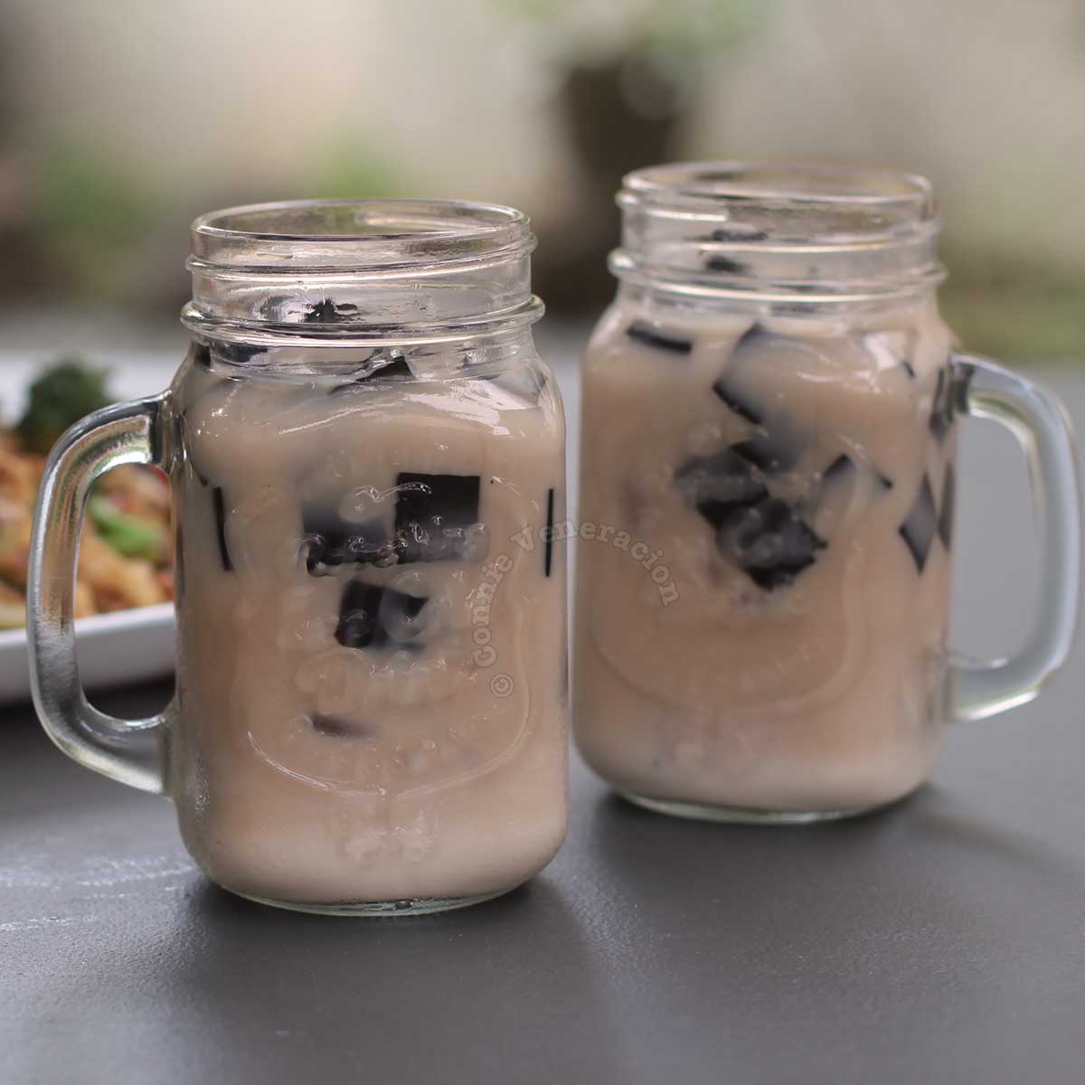 Grass jelly milk tea in Mason jars