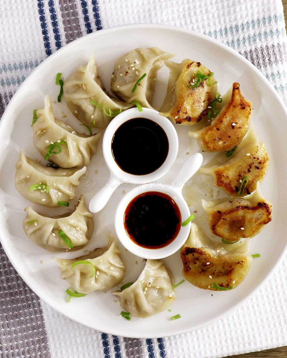 Gyoza on plate with dipping sauces
